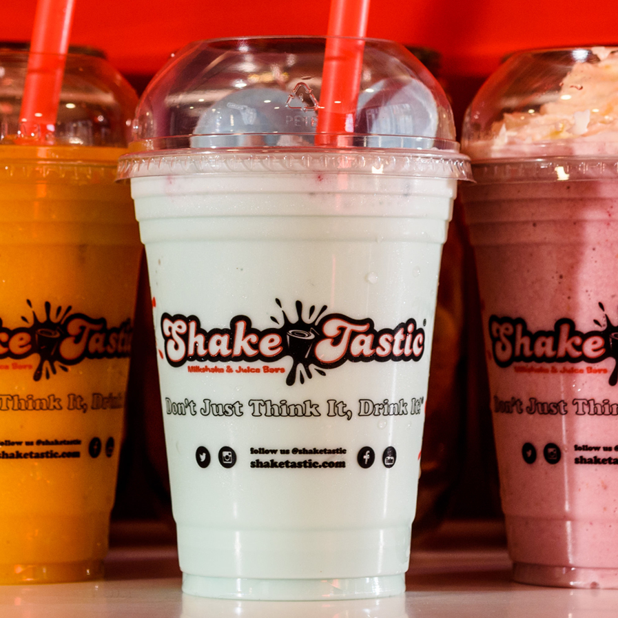 A ShakeTastic milkshake topped with cream and treats